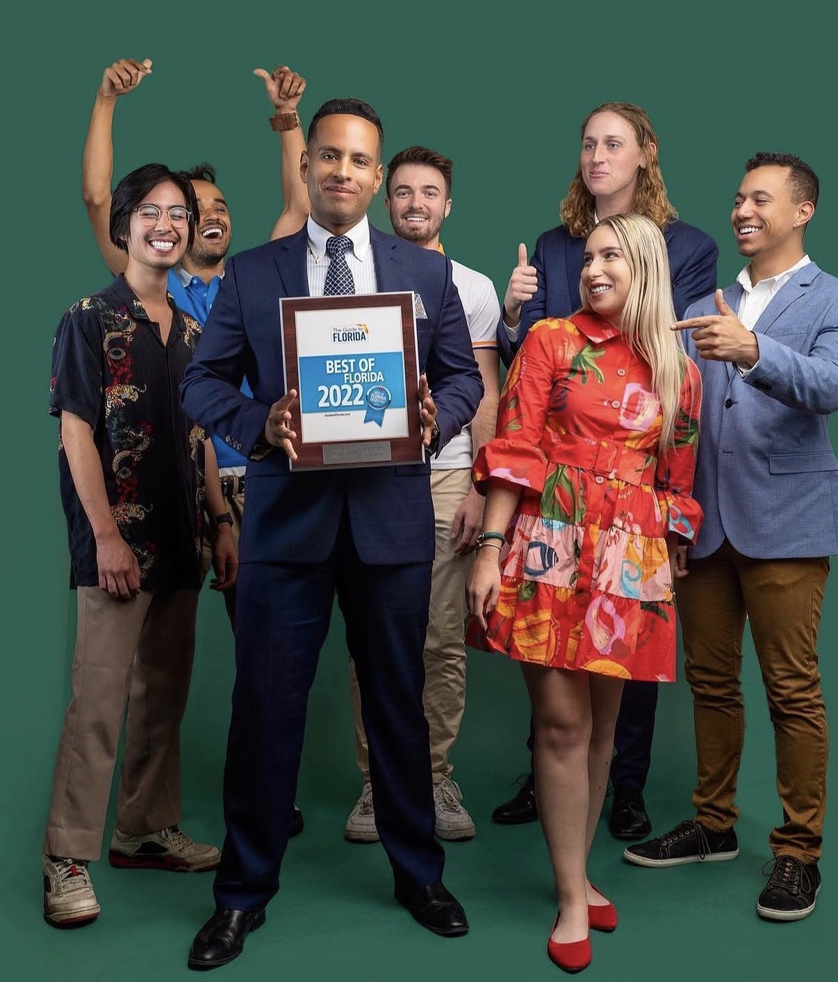 Andrew Goldstein holding the 2022 Best of Florida award with the Tally Entertainment team