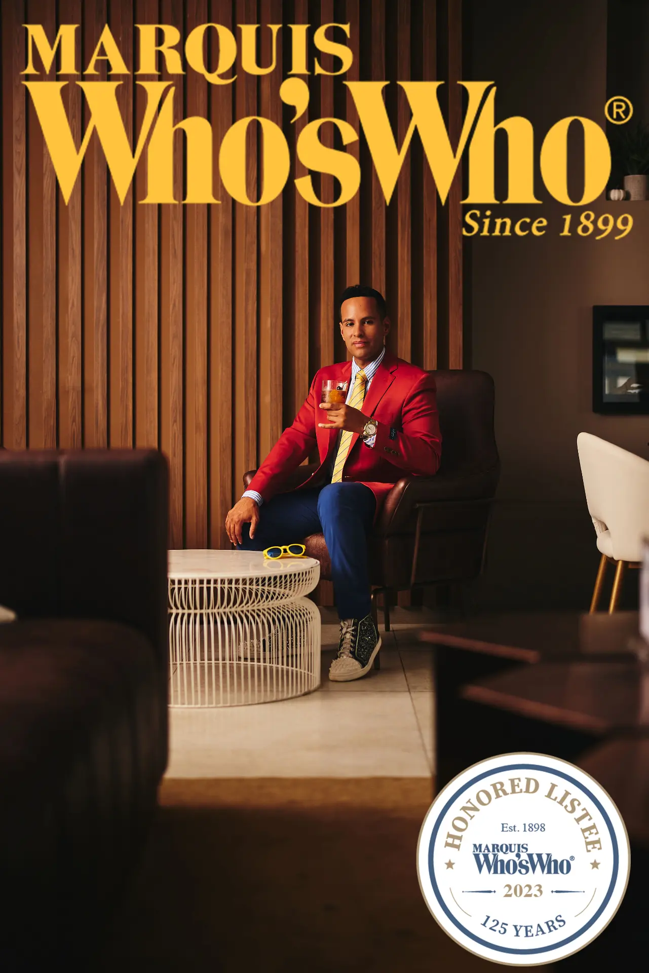 Andrew Goldstein seated beneath a Marquis Who's Who 2023 Honored Listee sign