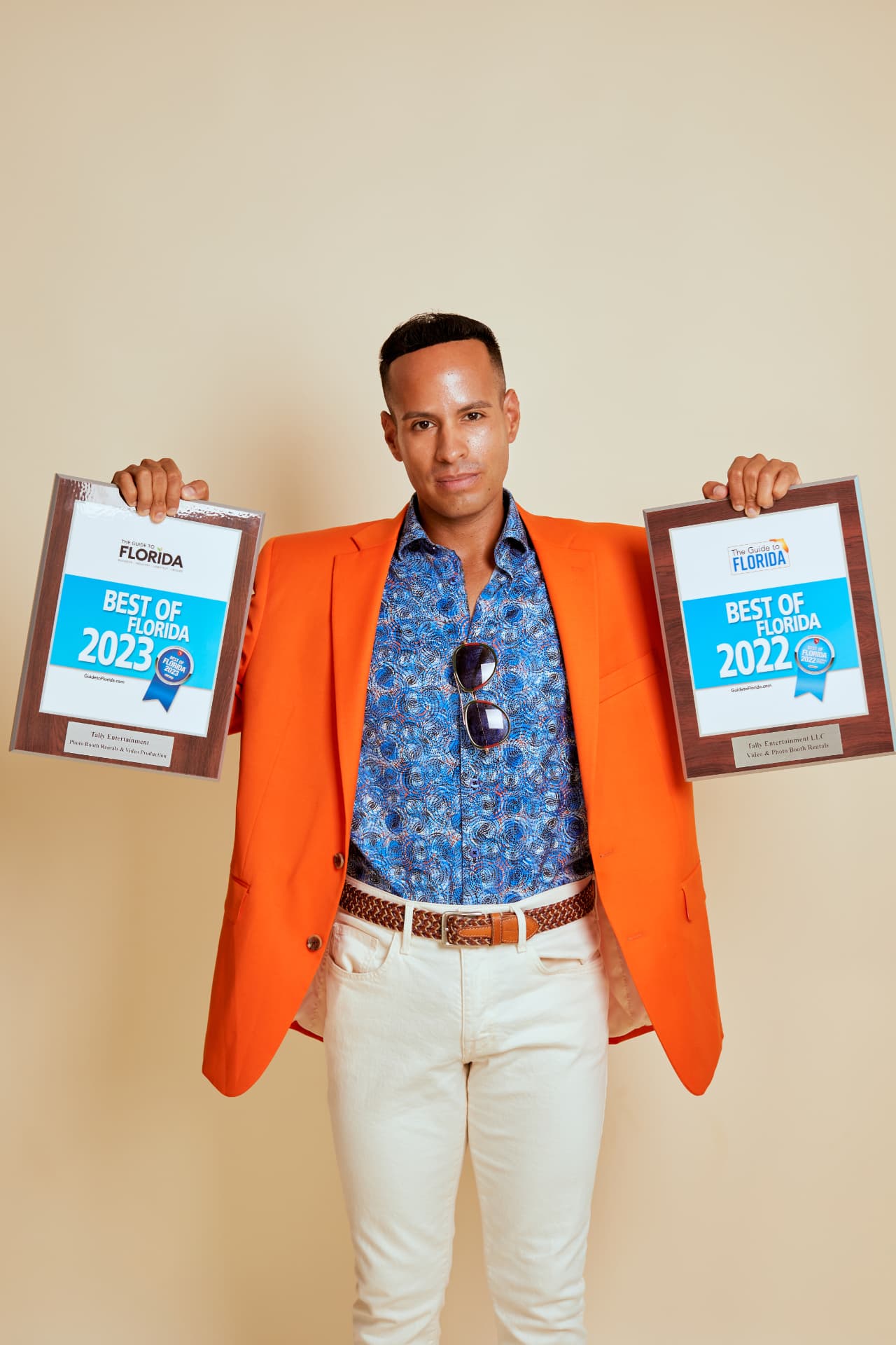 Andrew Goldstein holding two Best of Florida awards for Tally Entertainment